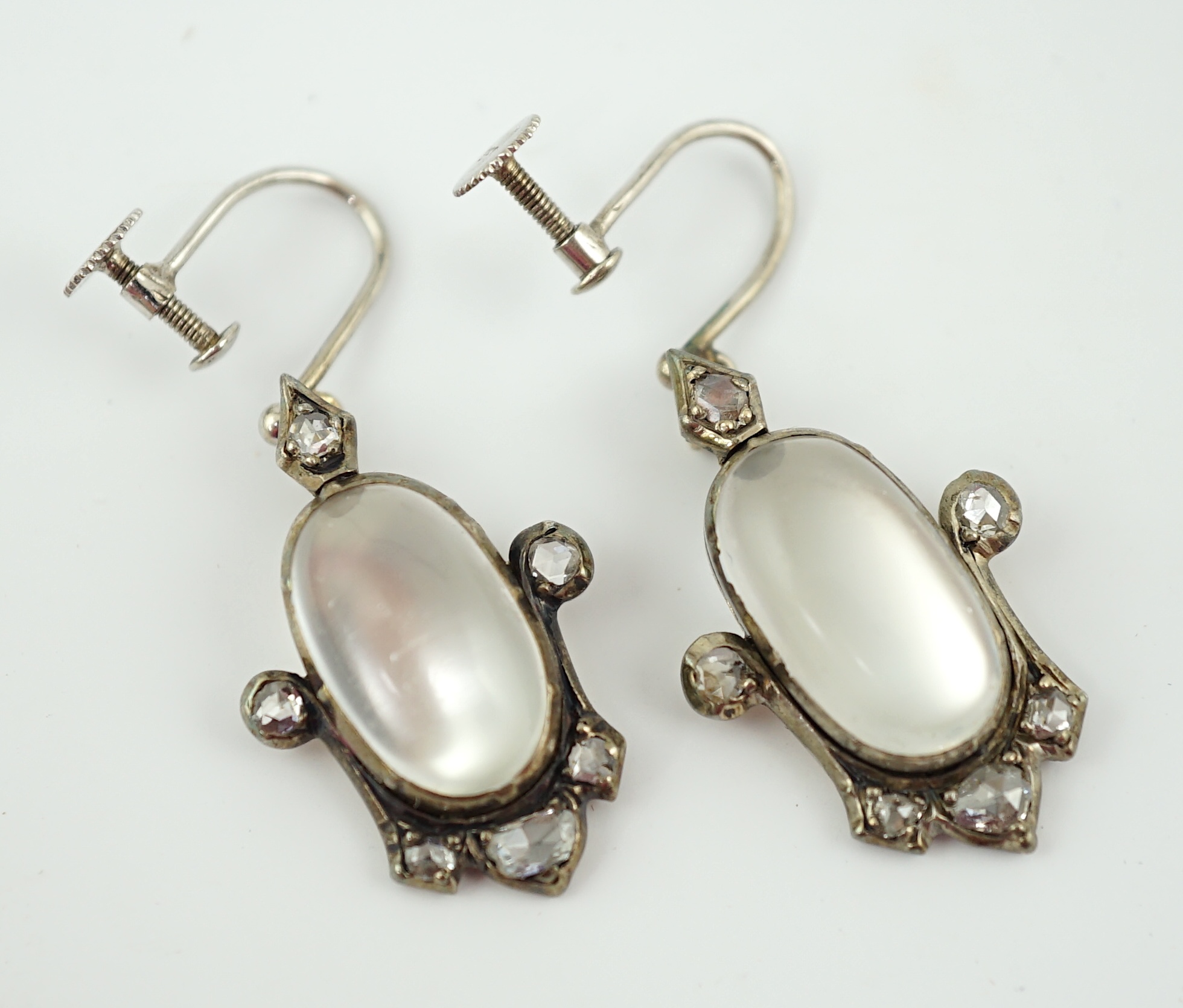 A pair of early 19th century gold and silver, cabochon moonstone and rose cut diamond cluster set drop ear clips